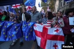 Supporters of Georgia's pro-Western and pro-EU opposition groups hold a joint final campaign rally ahead of the upcoming parliamentary elections in Tbilisi, Oct. 20, 2024.