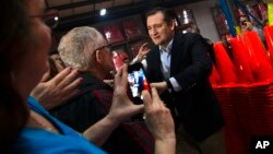 Republican presidential candidate, Sen. Ted Cruz greets supporters before speaking at a campaign stop, March 25, 2016, in Oshkosh, Wis.