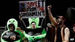 Mario Rayna, center, chants with others at an entrance to the Nevada Test and Training Range near Area 51, Sept. 20, 2019, near Rachel, Nev. People gathered at the gate inspired by the "Storm Area 51" internet hoax.