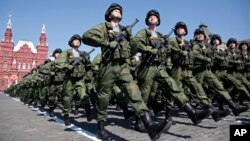 FILE - In this May 9, 2016 photo, Russian soldiers march during the Victory Day military parade marking 71 years after the victory in WWII in Red Square in Moscow, Russia. 