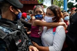Migrants attempt to cross the border from Corinto, Honduras, into Corinto, Guatemala, Oct. 1, 2020.