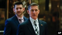 Retired Lt. Gen Michael Flynn talks to media as he arrives at Trump Tower, Nov. 17, 2016, in New York. 