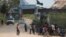 FILE - People are seen gathered outside a U.N. compound in the DRC's Ituri province capital of Bunia, Aug. 10, 2016. Thousand have fled the region in recent weeks due to a surge in intercommunal violence.