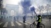 Protesters wearing yellow vests, a symbol of a FILE - French drivers' protest against higher diesel taxes, face off with French riot police during clashes at the Place de l'Etoile near the Arc de Triomphe in Paris, France, Dec. 1, 2018.