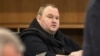 German tech entrepreneur Kim Dotcom sits in a chair during a court hearing in Auckland, New Zealand, Sept. 24, 2015. 