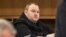 German tech entrepreneur Kim Dotcom sits in a chair during a court hearing in Auckland, New Zealand, Sept. 24, 2015. 