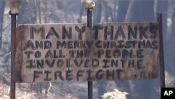 A sign offers thanks and a Merry Christmas in a destroyed residential area by wildfire, Dec. 23, 2019, in the Blue Mountains, New South Wales, Australia, in this image made from video.