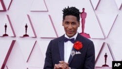 Musician Jon Batiste arrives at the Oscars awards ceremony in Los Angeles, on April 25, 2021. Batiste leads the nominations at the 2022 Grammys with 11 nominations.  (AP Photo/Chris Pizzello, Pool)