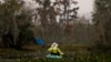 FILE - A kayaker paddles amidst changing foliage in the Maurepas Swamp in Ruddock, La., Dec. 13, 2020. 