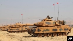 Turkey's Armed Forces soldiers in tanks take part in a military drill near the town of Silopi, Turkey, close to the Habur border gate between Turkey and the autonomous Kurdish region in Iraq, Sept. 18, 2017.