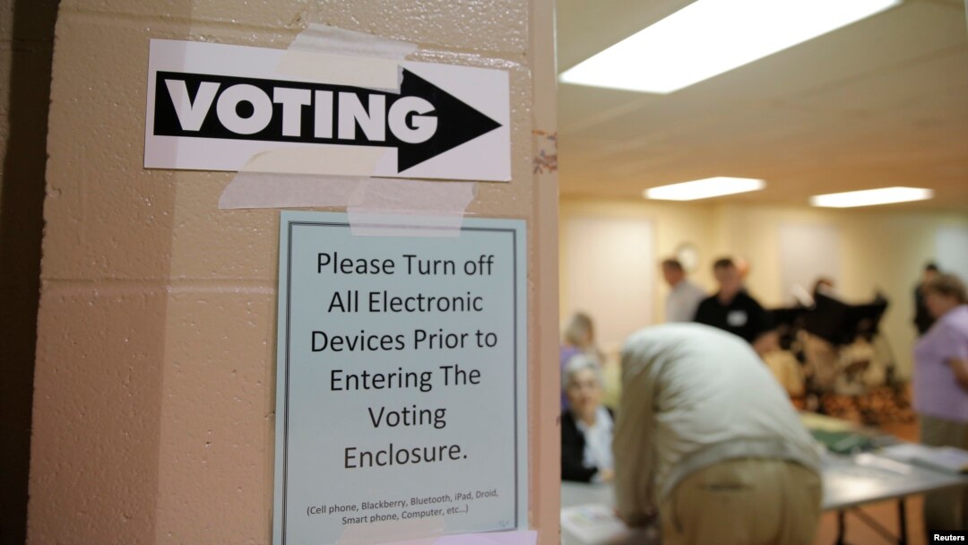 Sign points way to voting booths during presidential primary election at Sharon Presbyterian Church, Charlotte, North Carolina, March 15, 2016.