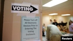 Sign points way to voting booths during presidential primary election at Sharon Presbyterian Church, Charlotte, North Carolina, March 15, 2016.