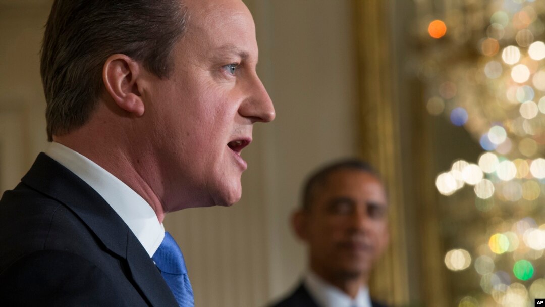 President Barack Obama listens as British Prime Minister David Cameron speaks during their joint news conference in the East Room of the White House, Jan. 16, 2015