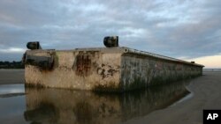 FILE - This Oregon Parks and Recreation Department photo shows the 66-foot Japanese dock that was torn away by Japan's 2011 tsunami and wound up on the sand at Agate Beach in Newport, Ore., July 31, 2012.