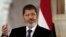 Egyptian President Mohammed Morsi speaks to reporters at the Presidential palace in Cairo, in this July 13, 2012 file photo.