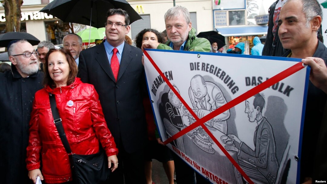 FILE - Rabbi Paul Chaim Eisenberg, left, and the president of the Jewish Community of Vienna, Oskar Deutsch, third from left, participate in a protest against anti-Semitism in Vienna, Sept. 12, 2012.