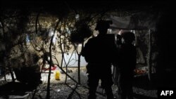 FILE - A U.S. Army officer, accompanied by an interpreter, talks to an Afghan resident while on a night patrol in Kandalay village, Afghanistan, Aug. 4, 2011.