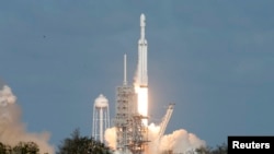 A SpaceX Falcon Heavy rocket lifts off from historic launch pad 39-A at the Kennedy Space Center in Cape Canaveral, Florida, Feb. 6, 2018. 