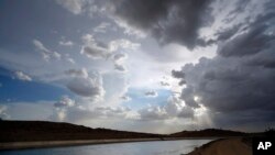 Water flows along the All-American Canal Saturday, Aug. 13, 2022, near Winterhaven, Calif. The canal conveys water from the Colorado River into the Imperial Valley.