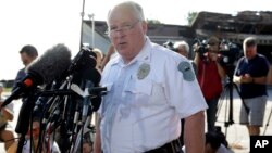 FILE - Ferguson Police Chief Thomas Jackson releases the name of Officer Darren Wilson, who fatally shot Michael Brown, an unarmed black teenager, Aug. 15, 2014.