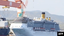 In this picture taken on April 22, 2020, cruise ship Costa Atlantica is docked at a port in Nagasaki. - At least 48 crew aboard a cruise ship docked in the Japanese city of Nagasaki have tested positive for coronavirus, local authorities said on…