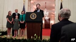 Supreme Court Justice Brett Kavanaugh speaks after a ceremonial swearing-in in the East Room of the White House in Washington, Oct. 8, 2018, as Senate Majority Leader Mitch McConnell looks on, right. On the dais is President Donald Trump, wife Ashley Kavanaugh and daughters Margaret, left, and Liza. 