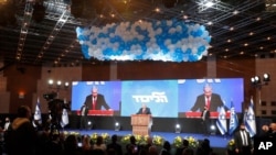 Prime Minister Benjamin Netanyahu addresses his supporters after the first exit poll results for the Israeli parliamentary elections at his Likud party's headquarters in Jerusalem, March 24, 2021. 