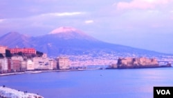 La imagen es una postal de Nápoles con el legendario Volcán Vesubio en el horizonte.