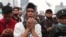 Muslim men pray during a protest against the new Job Creation Law approved by Parliament last week in Jakarta, Indonesia, Oct. 13, 2020. 
