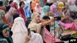Muslims gather for Eid al-Fitr prayers, which marks the end of the holy month of Ramadan, at the Bajra Sandhi Monument in Denpasar on the Indonesian resort island of Bali on April 10, 2024.
