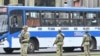 Soldiers stand guard in the streets of Lima on October 23, 2024, during a strike by transport workers and traders in demand of action from the government against a growing wave of extortion and murders by organized crime.