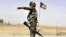 FILE - Afghan National Army soldier directs a vehicle to stop at a checkpoint on the way to Zhari district, where the Maiwand army base is located, in Kandahar, Afghanistan.