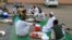 FILE —Muslim devotees wait to break their fast at a courtyard during the Islamic holy month of Ramadan in Gedaref on March 12, 2024.