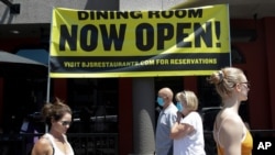 A restaurant advertises a re-opening Saturday, June 27, 2020, in Huntington Beach, Calif. (AP Photo/Marcio Jose Sanchez)