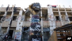 Rebel fighters walk inside Bab Al Azaziya compound in Tripoli August 26, 2011