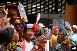 FILE - Demonstrators from the ’’Mayotte is Thirsty″ movement protest the water crisis in Mamoudzou, Mayotte, Sept. 27, 2023. They are demanding accountability for alleged embezzling, leaks and lack of investment in sustainable water supplies.