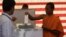 Cambodian Buddhist monk, right, casts his ballot in local elections at Wat Than pagoda's polling station in Phnom Penh, file photo. 
