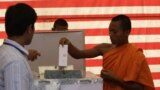 Cambodian Buddhist monk, right, casts his ballot in local elections at Wat Than pagoda's polling station in Phnom Penh, file photo. 