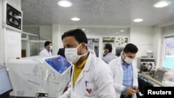 FILE - Medical staff wear face masks at a hospital amid concerns of the spread of the coronavirus disease (COVID-19) in Sana'a, Yemen, March 17, 2020. 