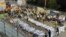 Israeli security officials and rescuers stand around the bodies of victims who died in a stampede at a religious festival attended by tens of thousands of ultra-Orthodox Jews, April 30, 2021.