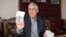 Muhammad Bekjanov, 63, a newspaper editor who was jailed for 18 years, shows a photo of himself taken at a younger age, after being released in February at his home in Yangibazar, Uzbekistan, March 1, 2017. 