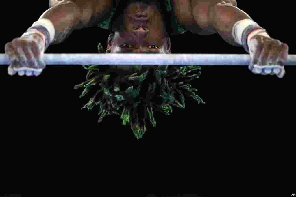 Uche Eke, of Nigeria, competes on the horizontal bar during the men&#39;s artistic gymnastic qualifications at the 2020 Summer Olympics, Saturday, July 24, 2021, in Tokyo, Japan. (AP Photo/Gregory Bull)