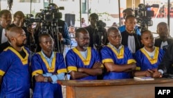 FILE - Defendants accused of belonging to the M23 rebel group look on while at the Ndolo prison in Kinshasa, Democratic Republic of the Congo, during their sentencing on Aug. 8, 2024.