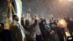 Free Syrian Army supporters chant anti government slogans under snowfall on the outskirts of Idlib, Syria, Feb. 29, 2012. 