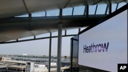 FILE - A photo shows a large screen at Heathrow Airport Terminal 2 in London, Britain, April 23, 2014.