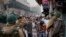 Indian policemen stop protesters at a police barricade in New Delhi, India, Dec. 20, 2019.