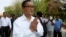 Cambodian main opposition Cambodia National Rescue Party leader Sam Rainsy, front, greets his supporters as his arrives at Choeung Ek memorial on the outskirts of Phnom Penh, Cambodia, Friday, May 17, 2015. 