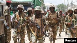 Djibouti soldiers serving in the African Union Mission in Somalia (AMISOM) patrol the south central town of Beledweyne in Somalia, May 9, 2013.