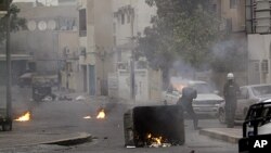 Riot police fire tear gas toward anti-government demonstrators in Musalla, Bahrain, on the edge of the capital of Manama, February 16, 2012.