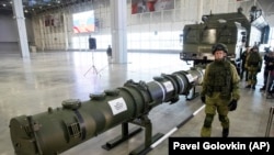 RUSSIA -- A Russian military officer walks past the 9M729 land-based cruise missile on display with its launcher, right, in Kubinka outside Moscow, Russia, Wednesday, Jan. 23, 2019